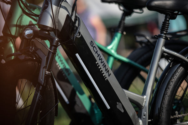 Close-up image of two different colored Schwinn electric bikes and their motors